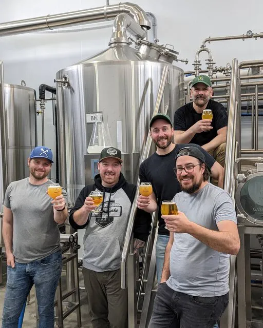 Brewer operating 10BBL brewing equipment at Brasserie Artisanale