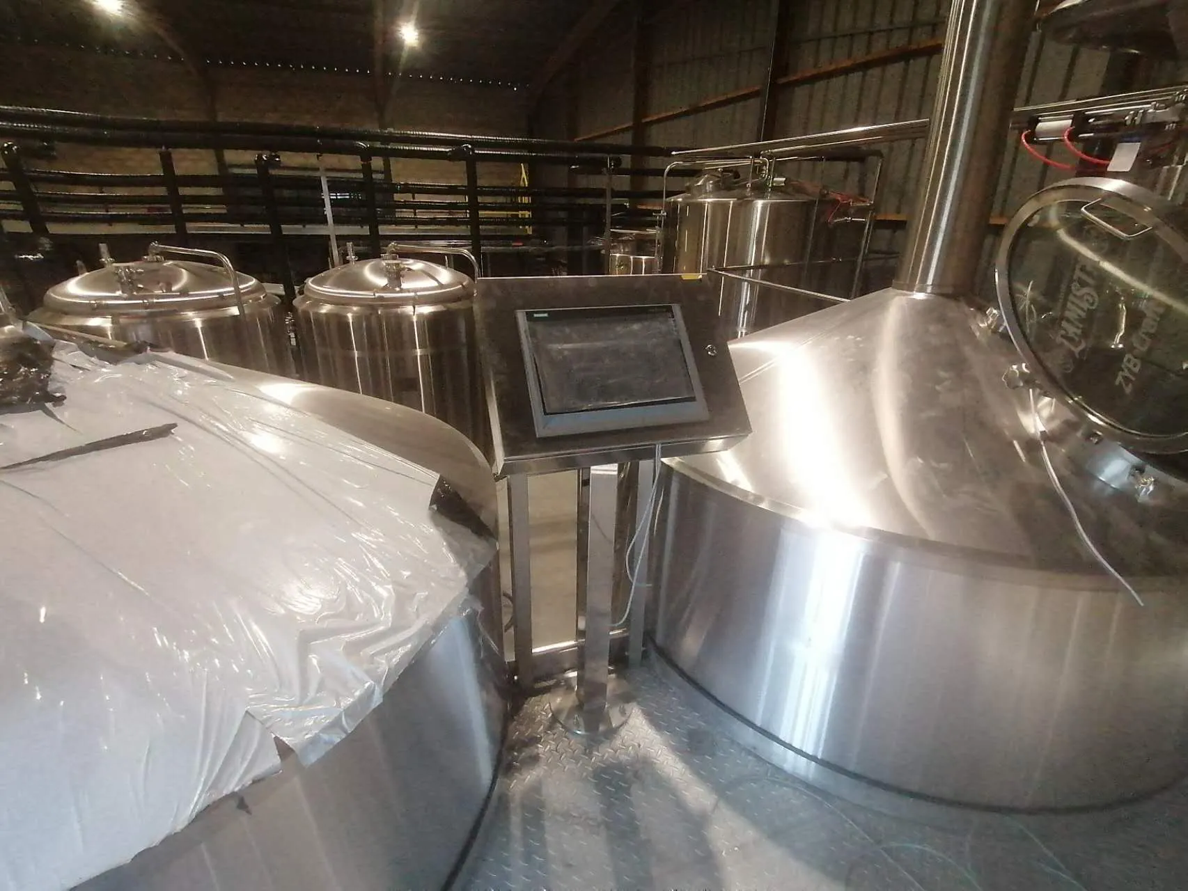 Brewmaster operating 25HL brewery equipment at Brasserie L'Amista