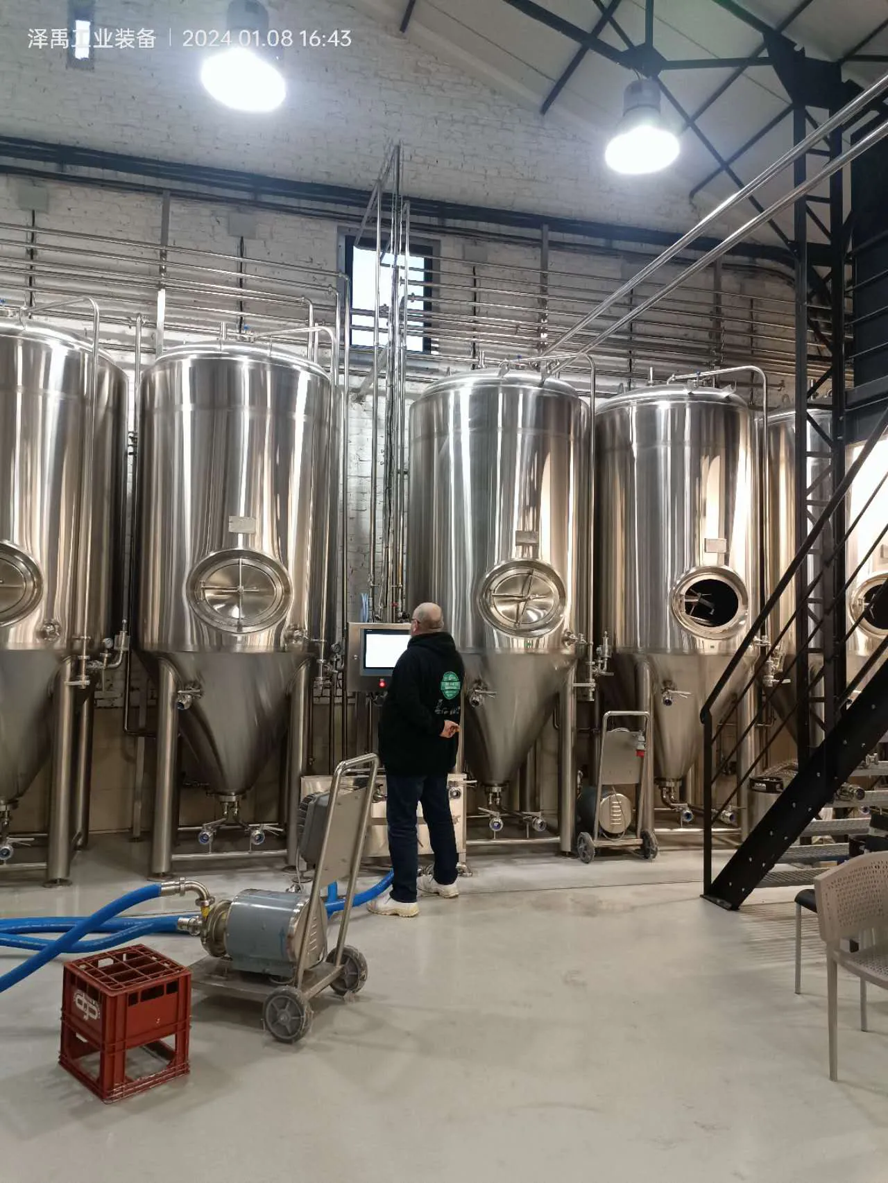 Brewmaster working with 10HL brewery equipment at Brasserie La Mousserie