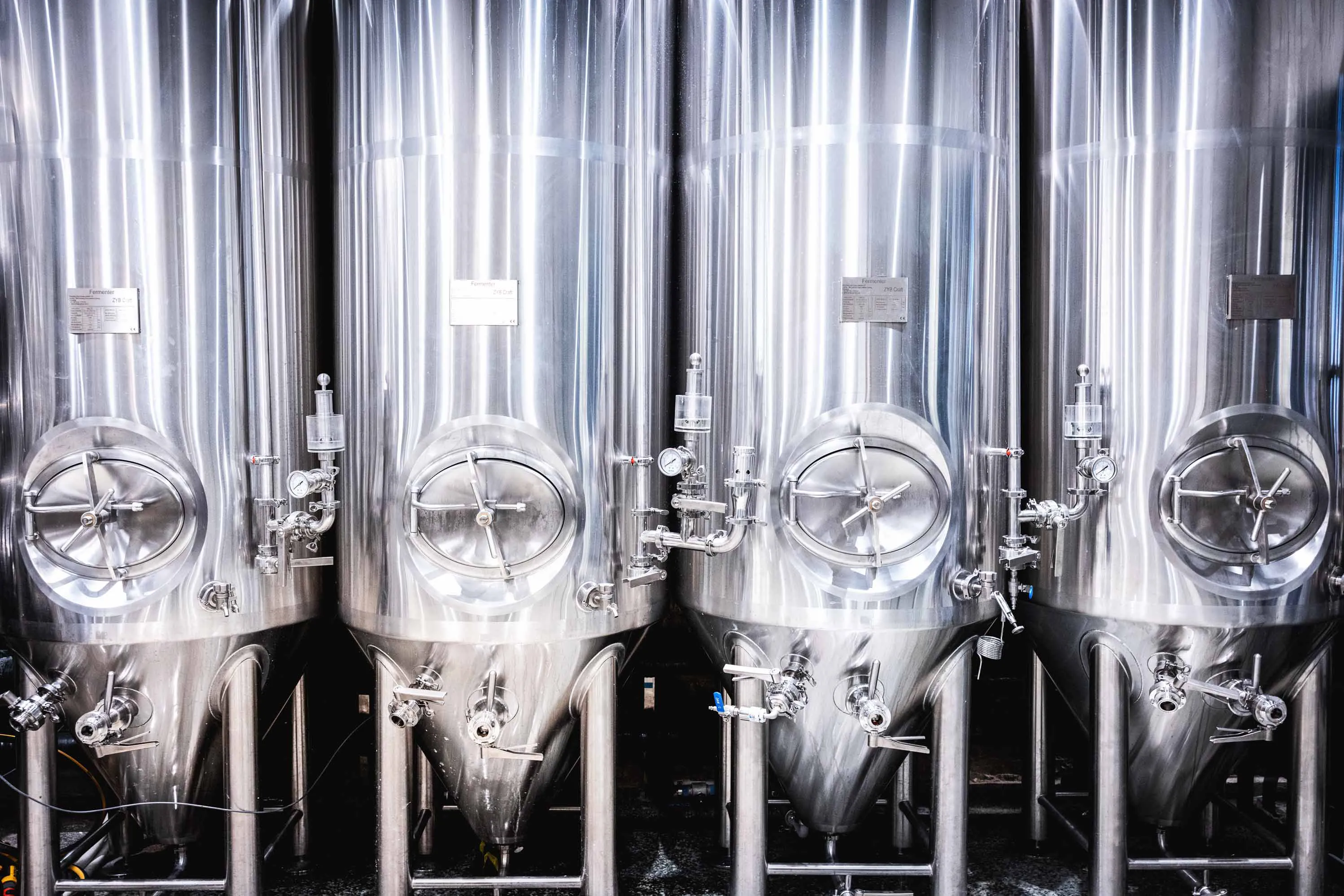 Technician operating 7BBL brewing equipment at Taberna Nacional